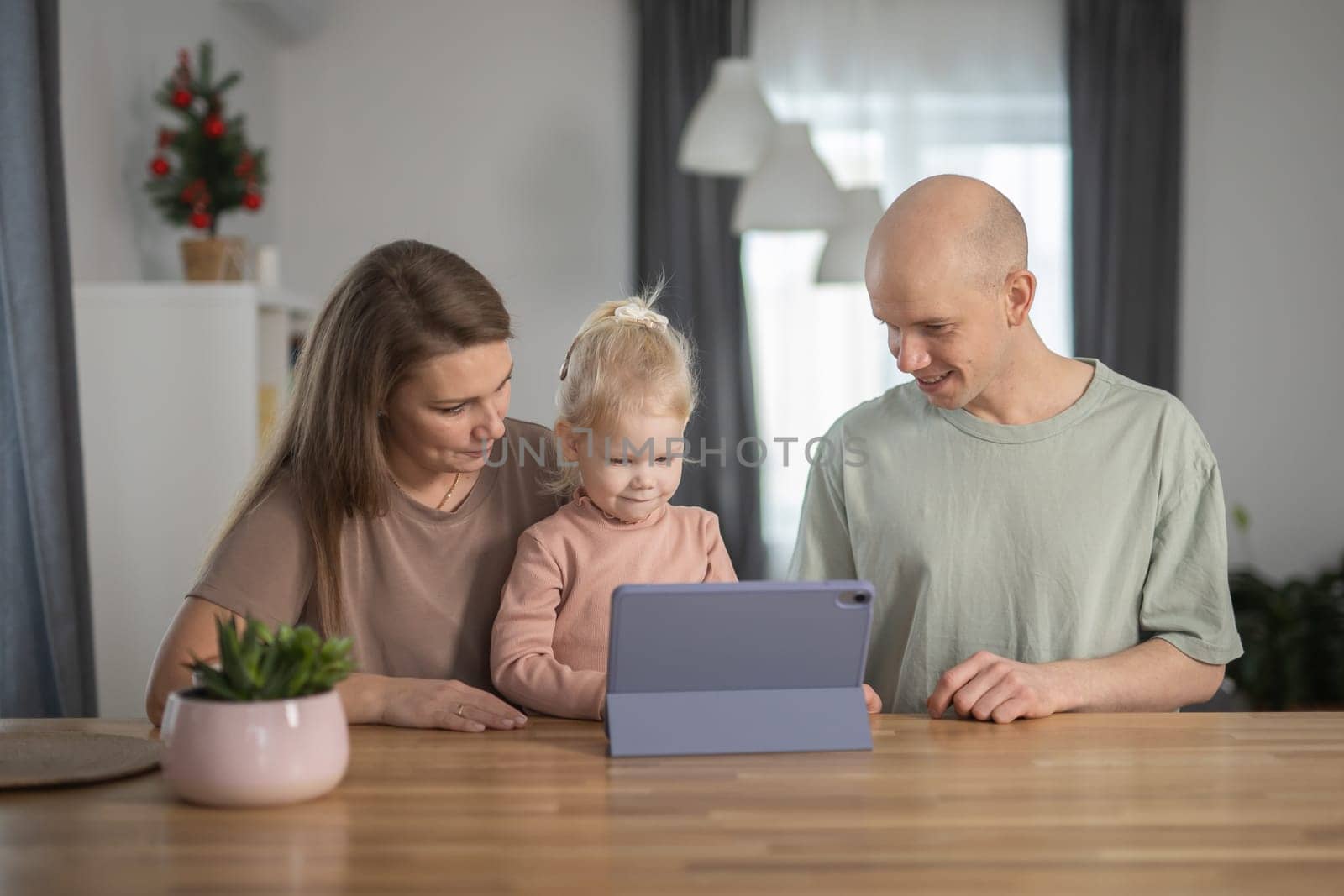 Deaf child girl with cochlear implant studying to hear sounds and have fun with mother and father - recovery after cochlear Implant surgery and rehabilitation concept by Satura86