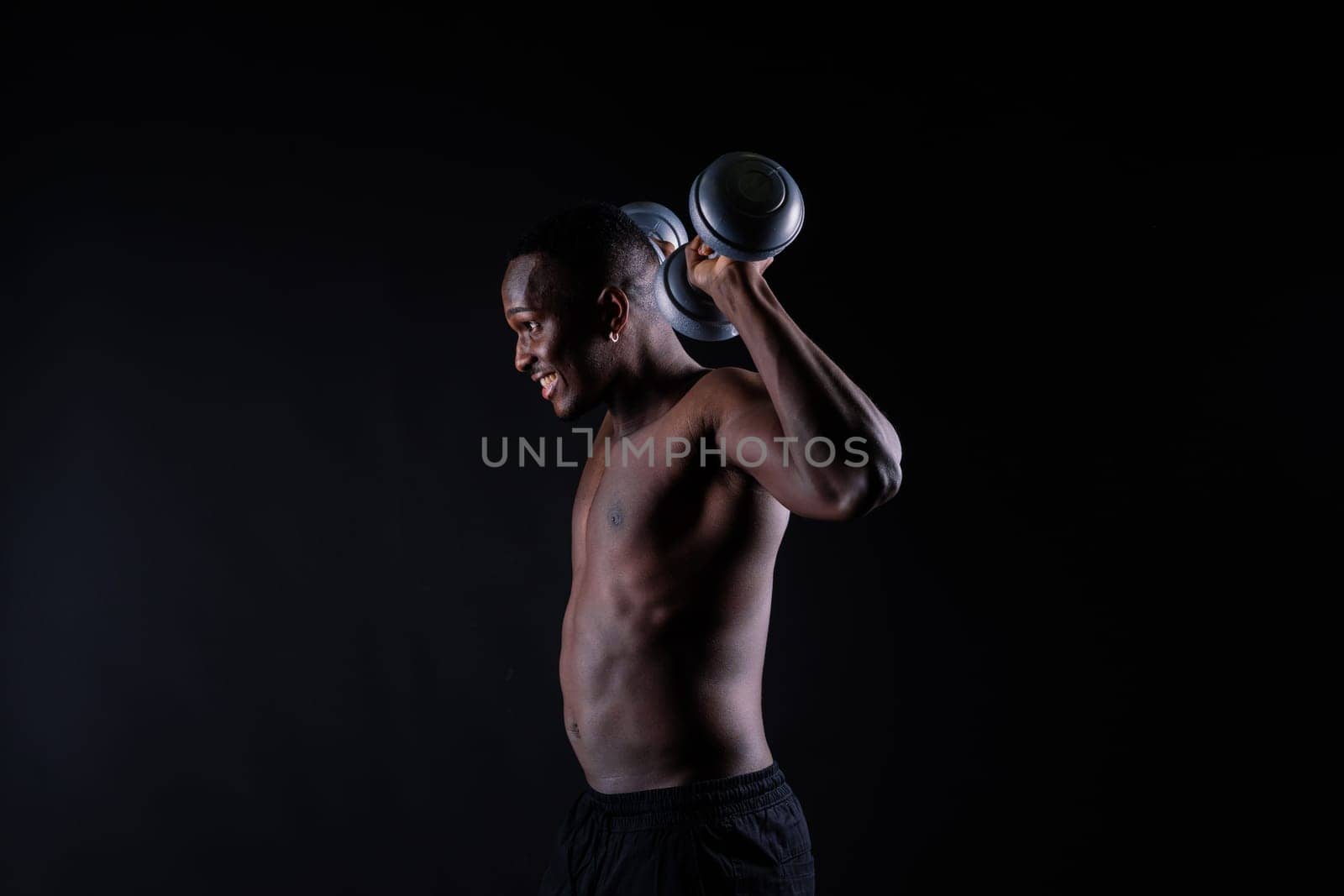 Muscular black african man with defined muscles abs abdominal, exercise determination and success by Zelenin