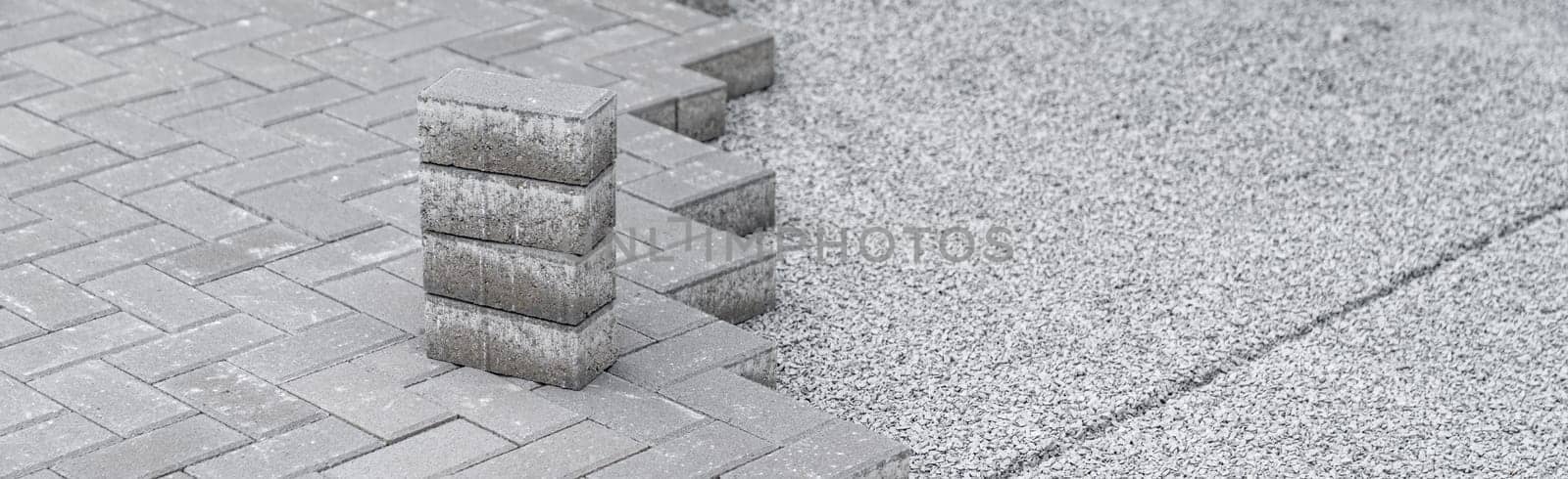 building a sidewalk, laying interlocking pavers.