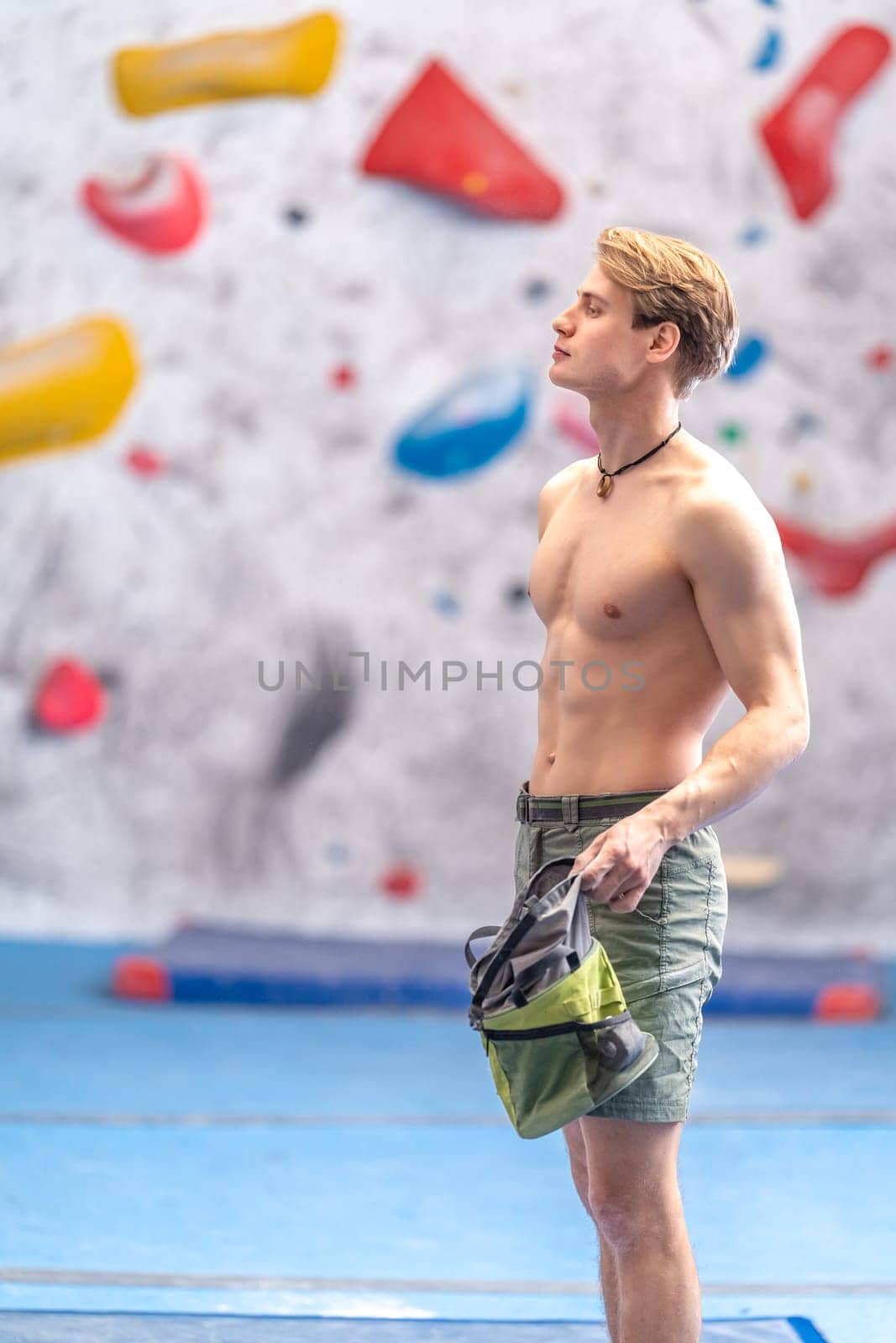 young man on a boulder climbing wall. High quality photo