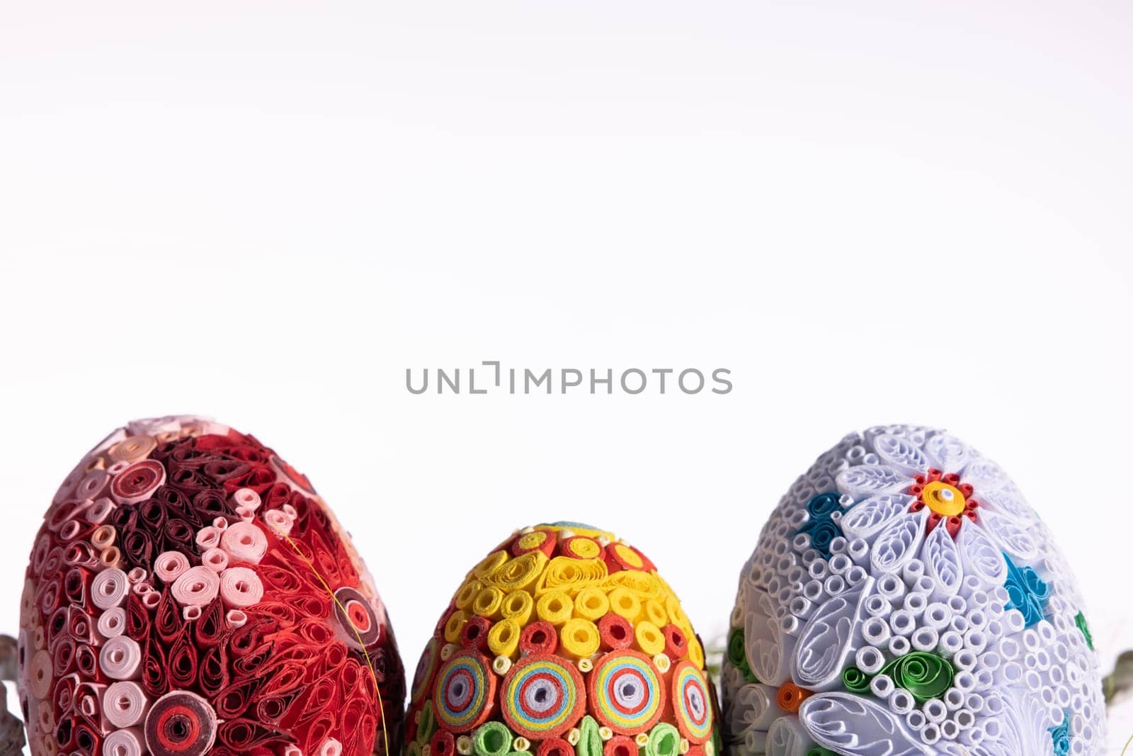 A masterpiece of handmade Easter eggs can be seen on a uniform clean background. Ornaments in honor of the Christian holiday.