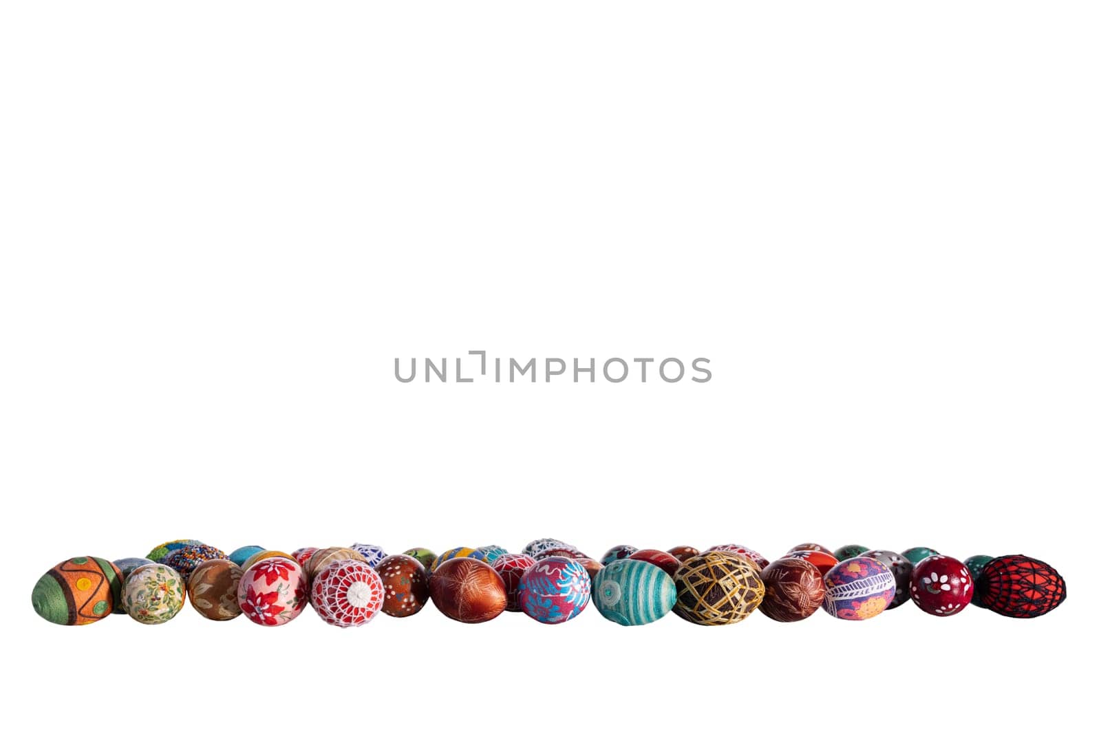 Original Easter eggs arranged one next to the other in different colors and patterns on a solid white background. Easter decoration to complete on your own.