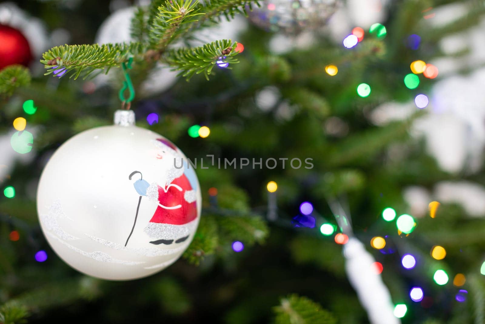 Christams tree with bauble. White bauble with Santa Claus.