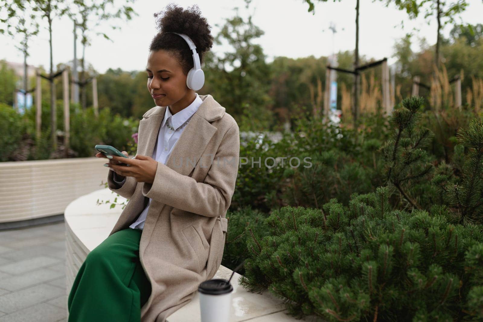 free african girl student in headphones on the street listening to music.