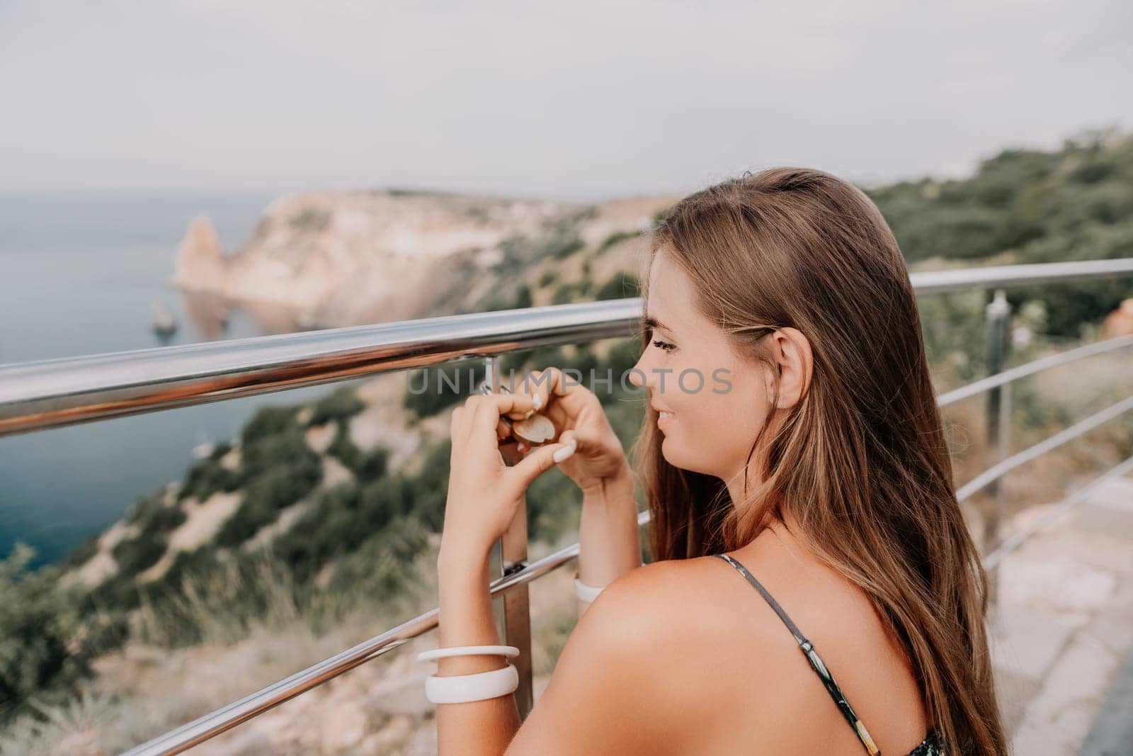 Hand, lock, heart, love, valentines day. Close up view of a woman holding a heart shaped lock that is locked onto a chain link fence.