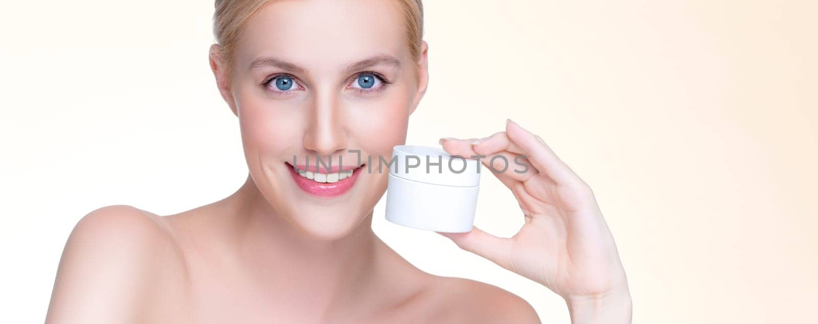 Personable beautiful perfect natural skin woman hold mockup tube moisturizer cream for skincare treatment product advertisement in isolated background with expressive facial and gesture expression.