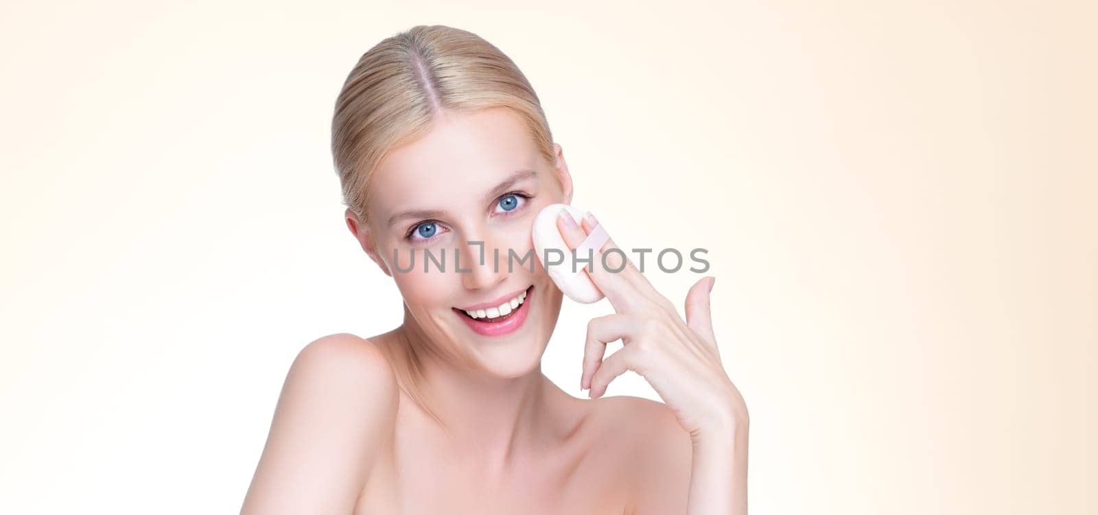 Personable beautiful natural soft makeup woman using powder puff for facial makeup concept. Cushion foundation applying on young girl face in isolated background.