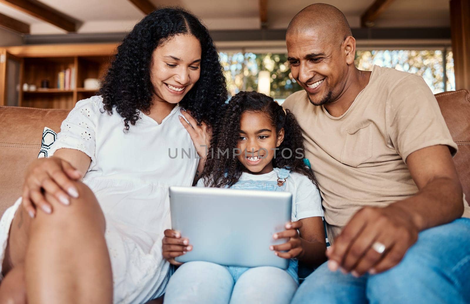 Family, relax and girl with tablet on sofa in home living room for social media, video streaming or internet browsing. Technology, love and happy father, mama and child with touchscreen for learning. by YuriArcurs