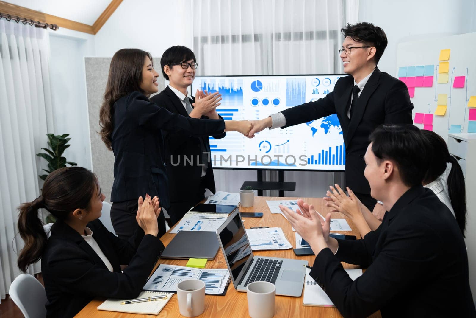 Businesspeople shake hand after successful agreement or meeting. Office worker colleague handshake with business team leader manager for strong teamwork in office to promote harmony and unity concept.