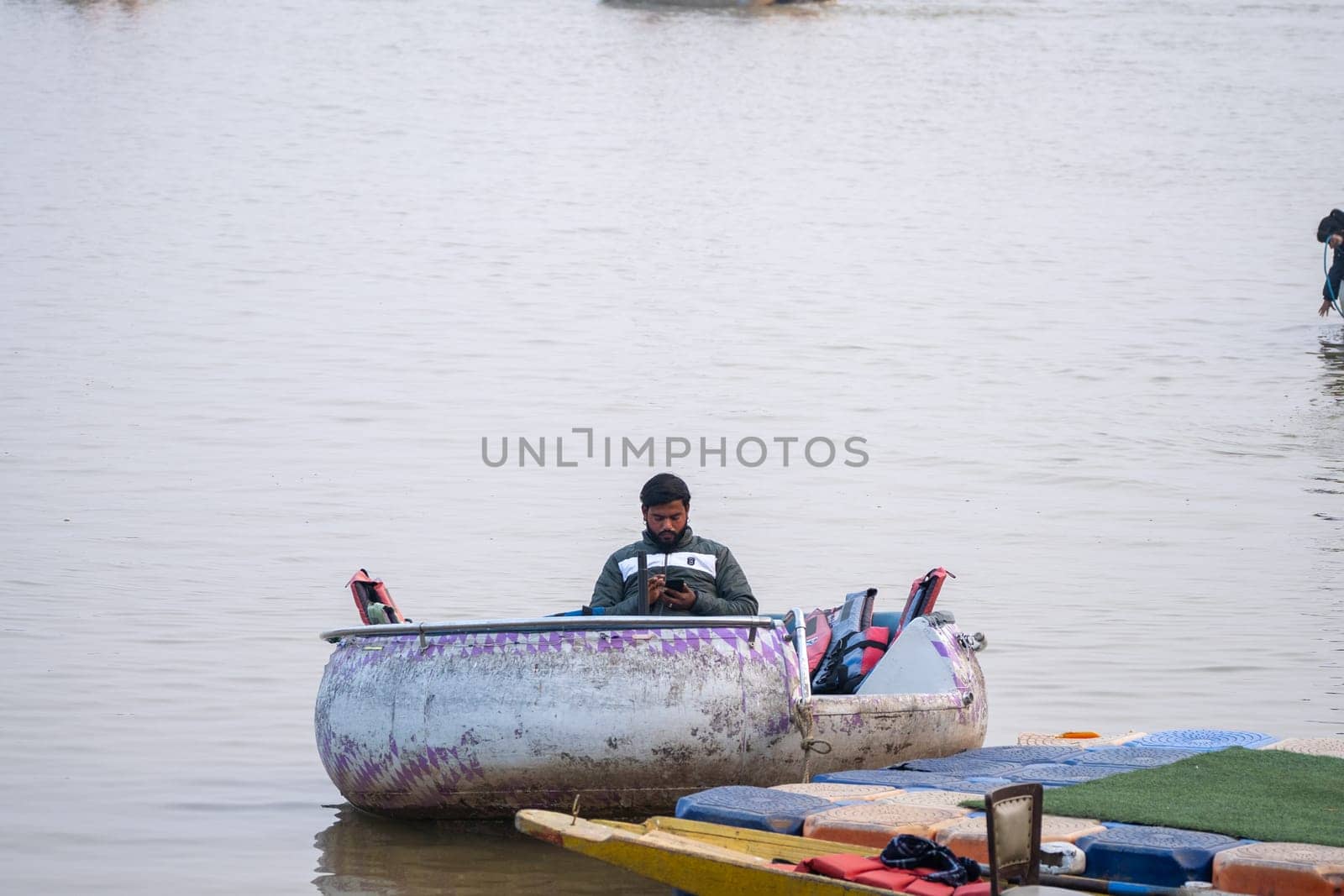 couple enjoying a pedal boat decorated beautifully on the landmark sukhna lake in chandigarh with more boats in the distance showing this popular tourist spot by Shalinimathur