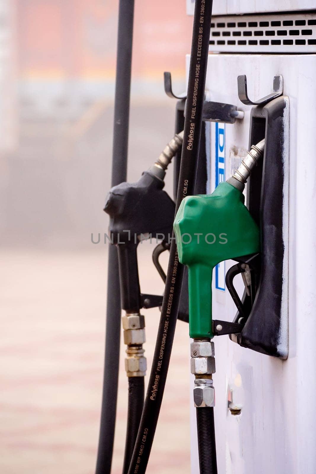 old damaged fuel pump nozzle showing petrol and deisel in india as the price increases and electric vehicles take over globally