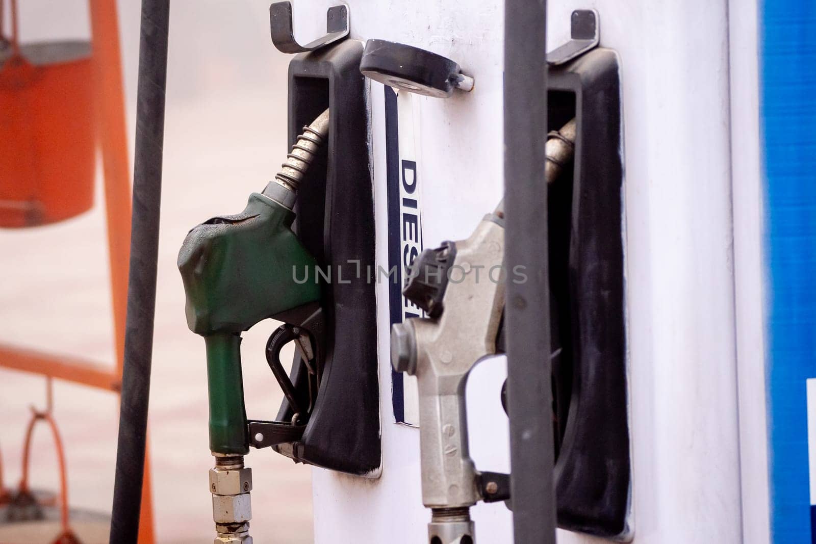 old damaged fuel pump nozzle showing petrol and deisel in india as the price increases and electric vehicles take over globally