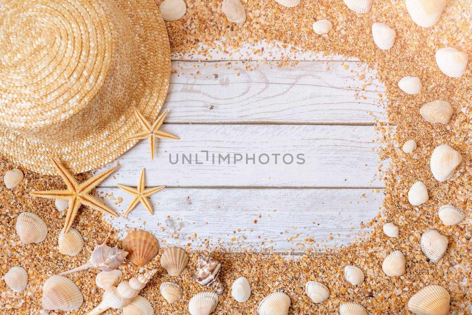 Sand seashells background. Summer time concept with sea shells and starfish on wooden background and sand by Matiunina