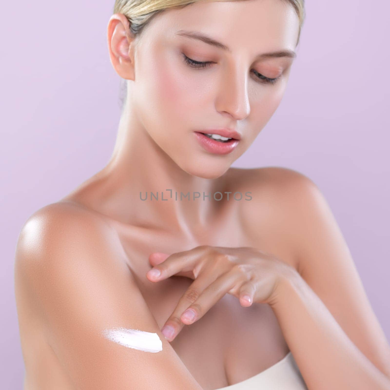 Closeup alluring beautiful woman apply moisturizer cream on her arm concept. by biancoblue