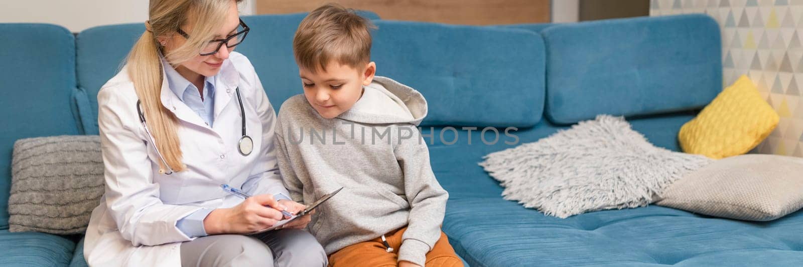 A family doctor examines a little boy at home. Pediatrician girl treats a child by malyshph