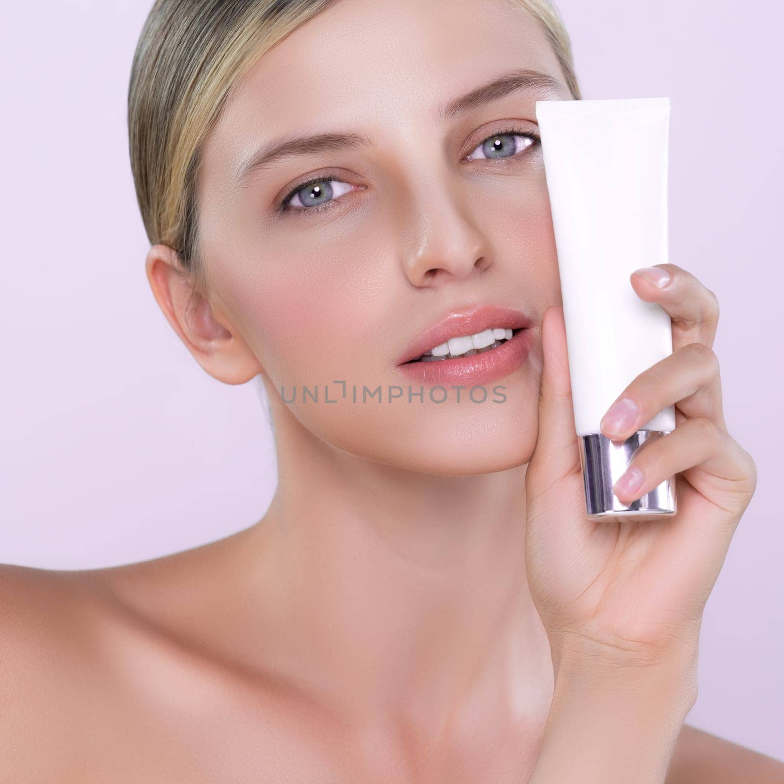 Alluring beautiful perfect cosmetic skin woman portrait hold mockup tube cream or moisturizer for skincare treatment, anti-aging product in isolated background. Natural healthy skin model concept.