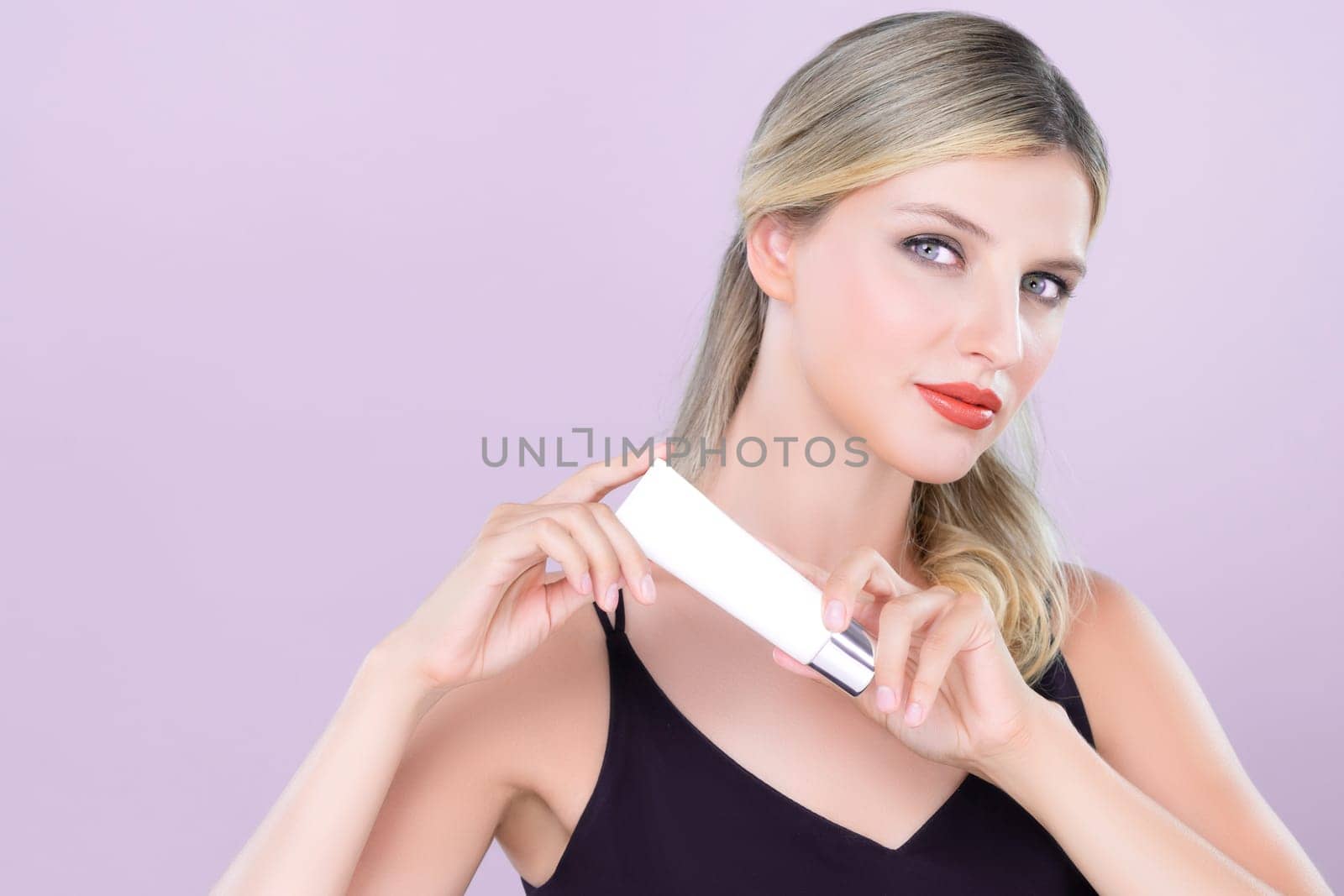 Alluring portrait of perfect skin woman holding mockup moisturizer tube. by biancoblue