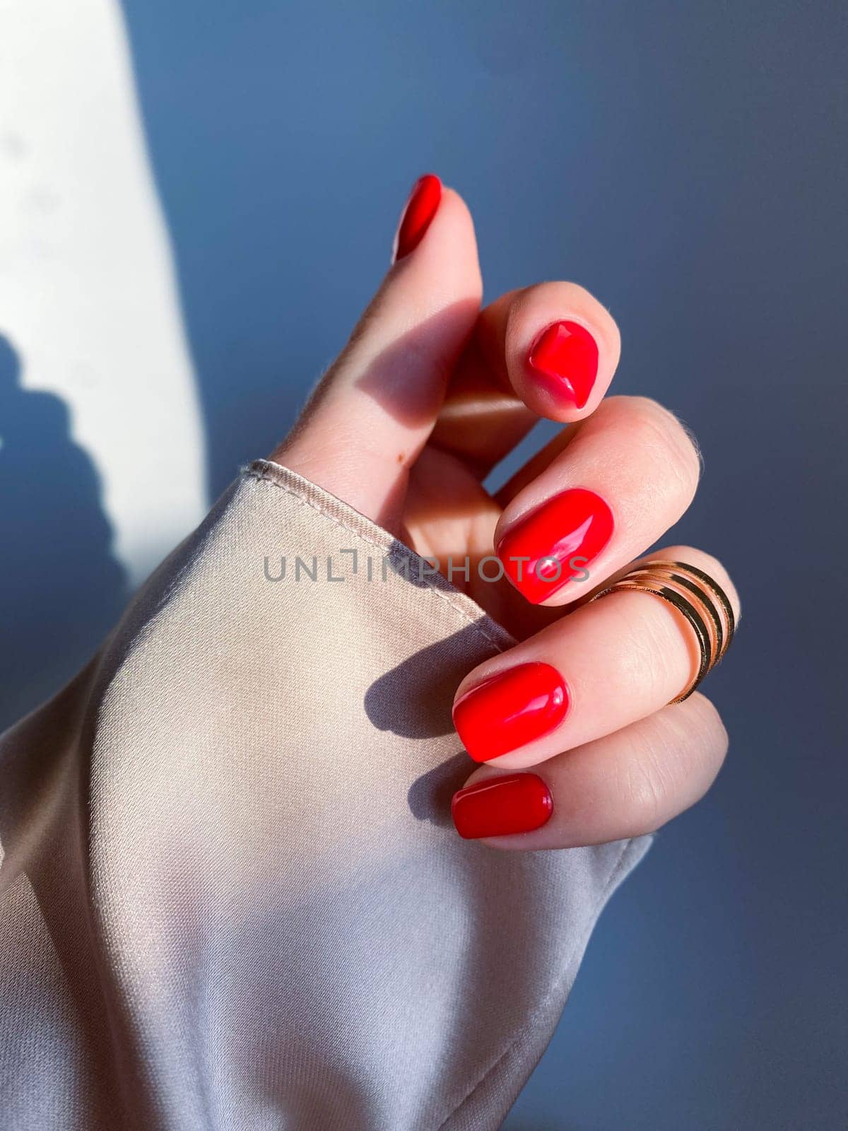 Beautiful nails manicure photo. Red color top nail polish. Female hand, rings, closeup photo, aesthetics. Manicure design, square nail shape. Luxury style, Creative beauty photo, Woman hand. High quality photo. High quality photo by DailySF