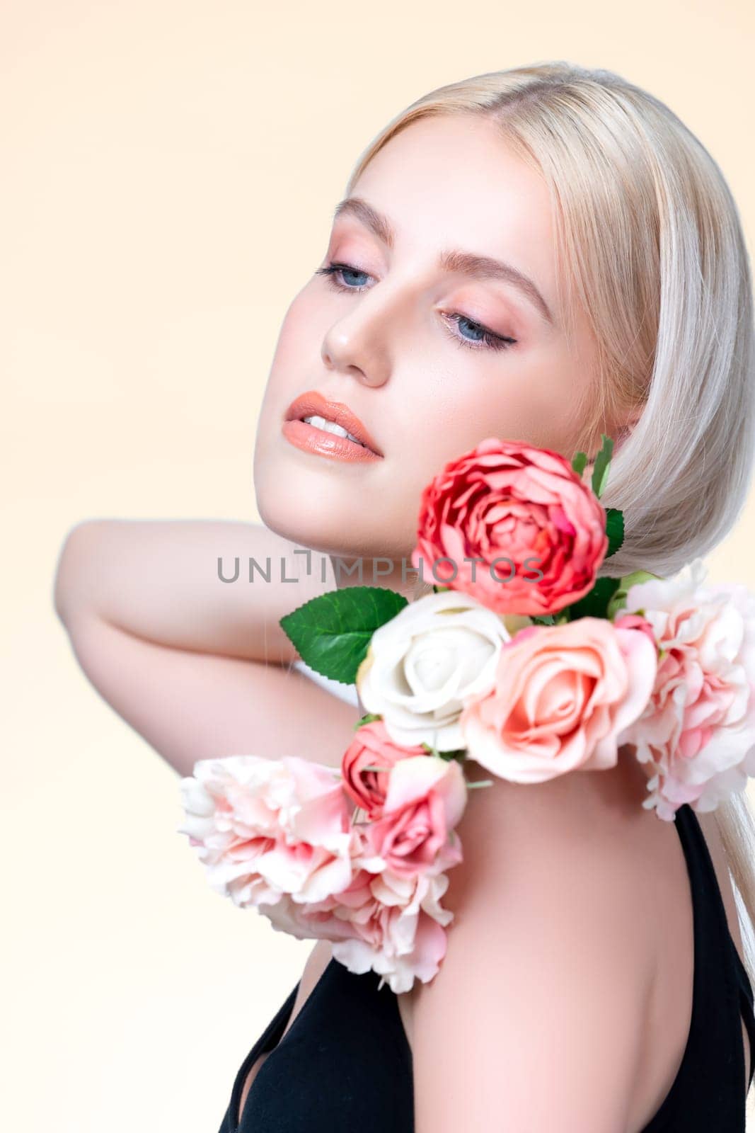 Closeup young personable woman with natural makeup and healthy soft skin holding rose for beauty care advertising in isolated background. Beautiful pretty model girl with flower concept.