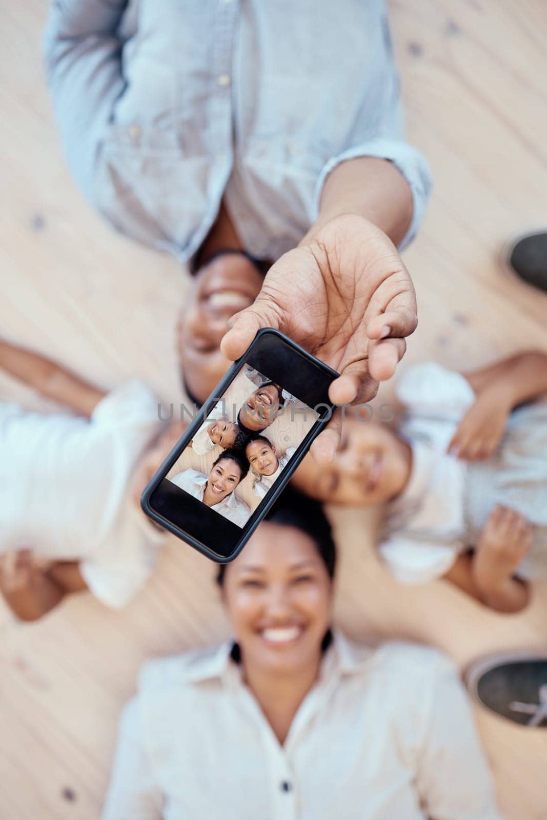 Top view, family and phone selfie in home for happy memory together on floor. Love, care and 5g mobile picture of happy mother, father and children bonding for social media, internet or online post