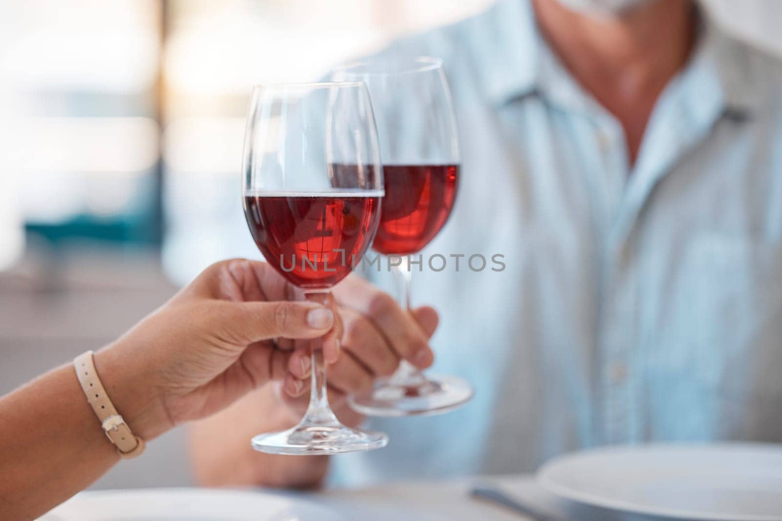 Hands, wine glasses and cheers for celebration dinner, date or table in thanks for fine dining at home. Hand of couple toasting with wine for relationship, romance and clinking glass for dating love by YuriArcurs