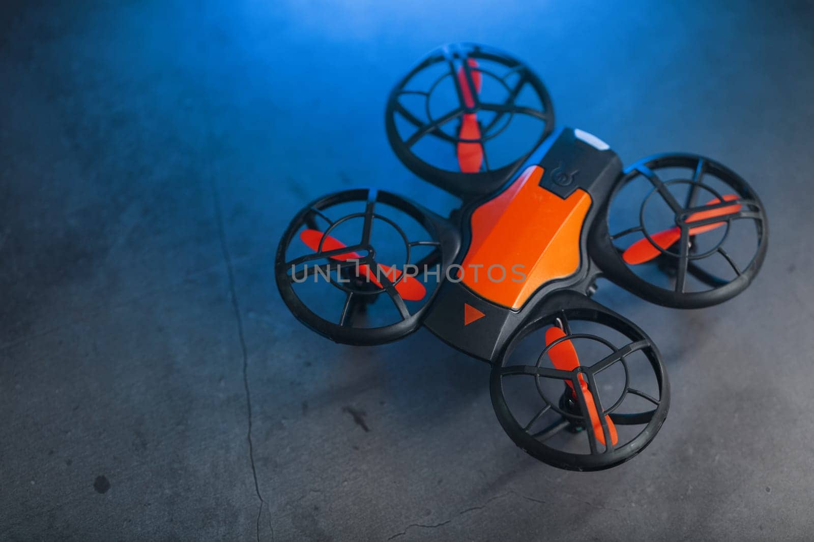 Gaming orange mini drone on a dark background by AlexGrec