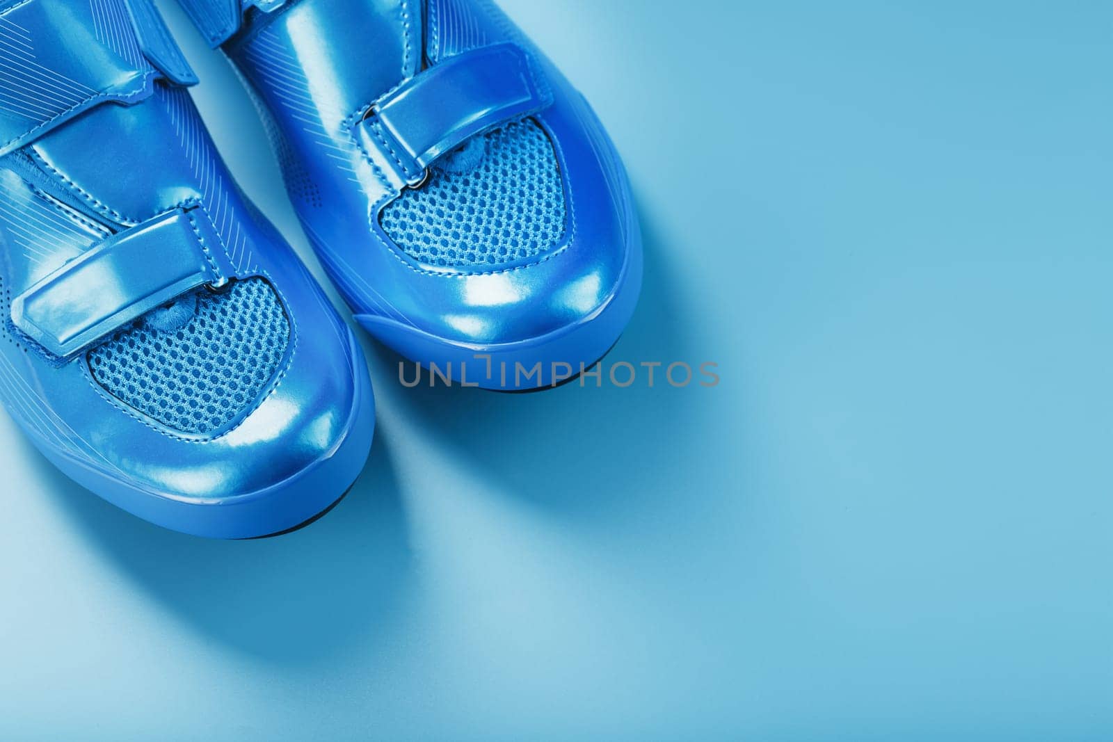 Blue highway cycling shoes on a blue background by AlexGrec