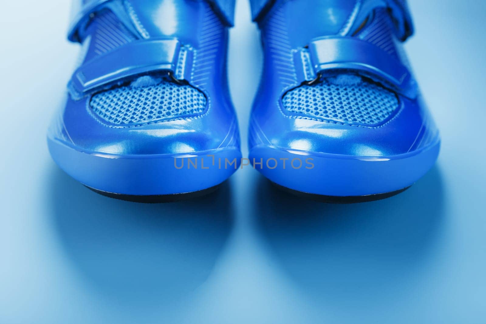 Blue Shiny Bicycle Shoes for Road Bike on Blue Background