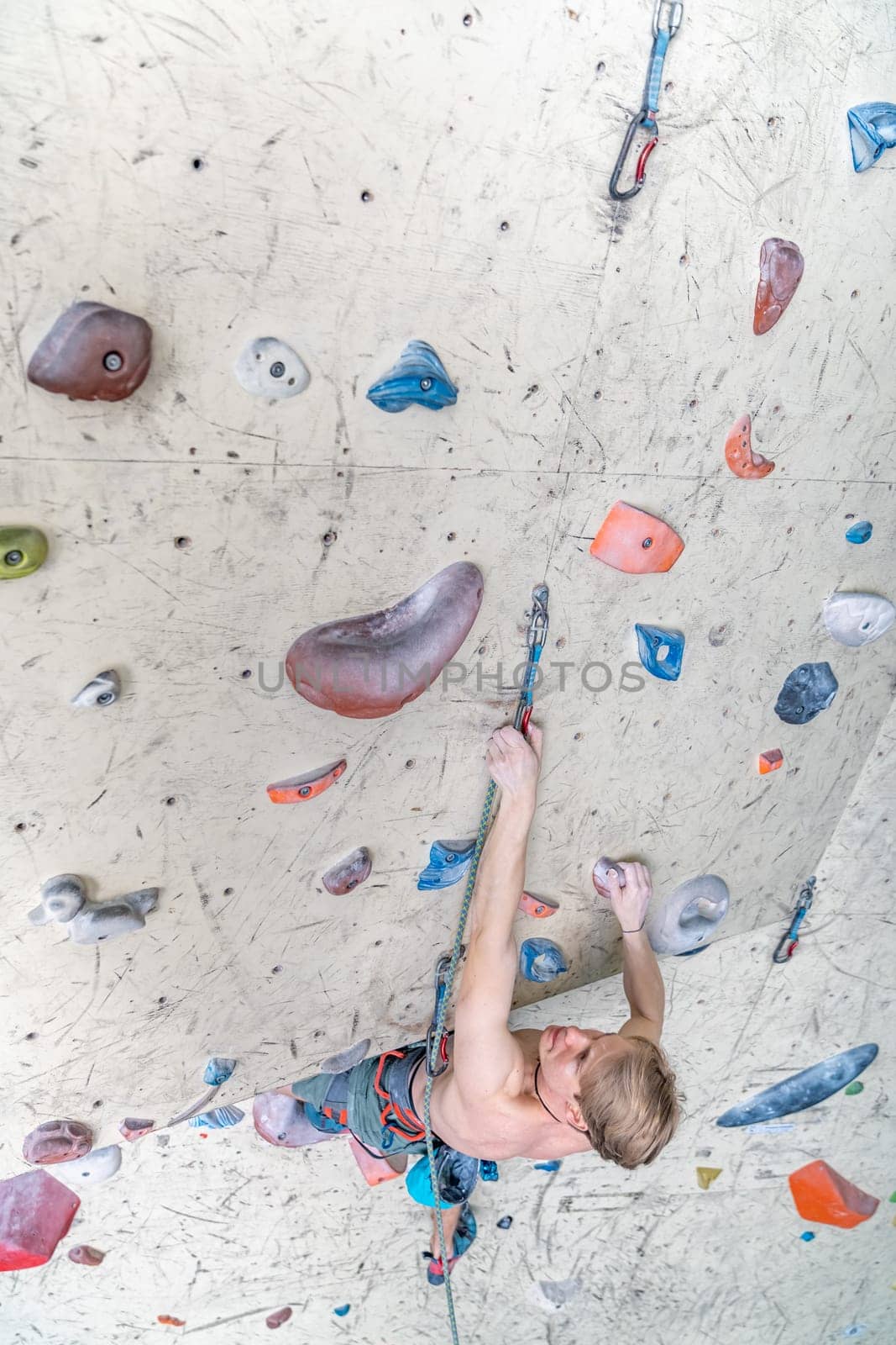climber with safety rope on an artificial climbing wall. High quality photo