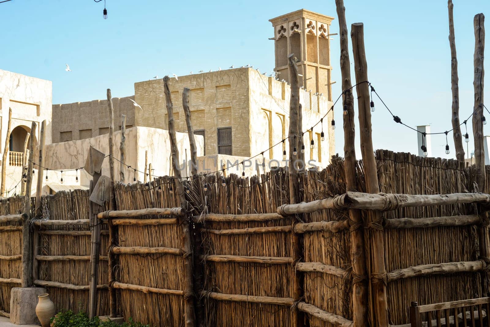 Narrow streets that create shade on a hot day in the old city of Dubai Creek and Bur district. Travel destinations and heritage village.