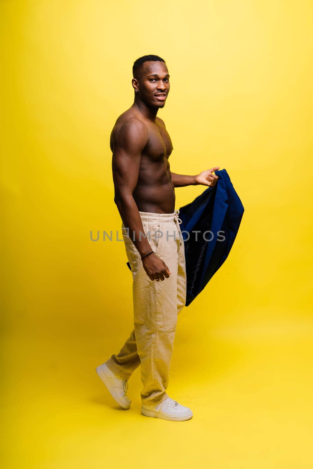 Young african man standing shirtless with a happy and cool smile on face. lucky person. by Zelenin