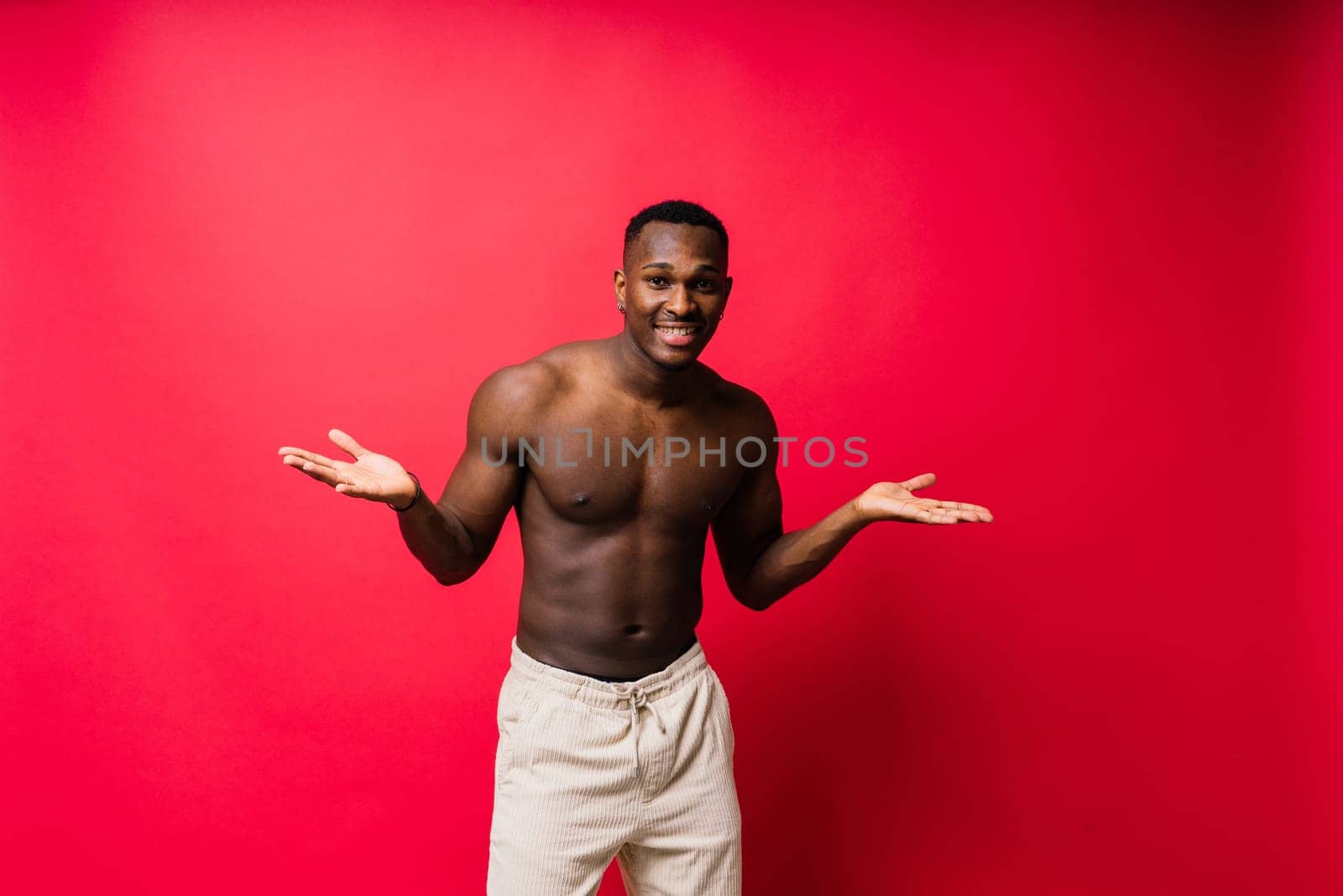 Young african man standing shirtless with happy and cool smile on face. lucky person.