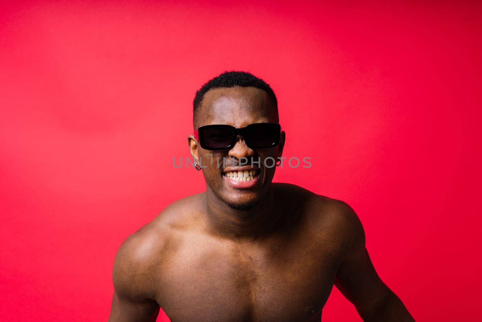 Young african man standing shirtless with happy and cool smile on face. lucky person.