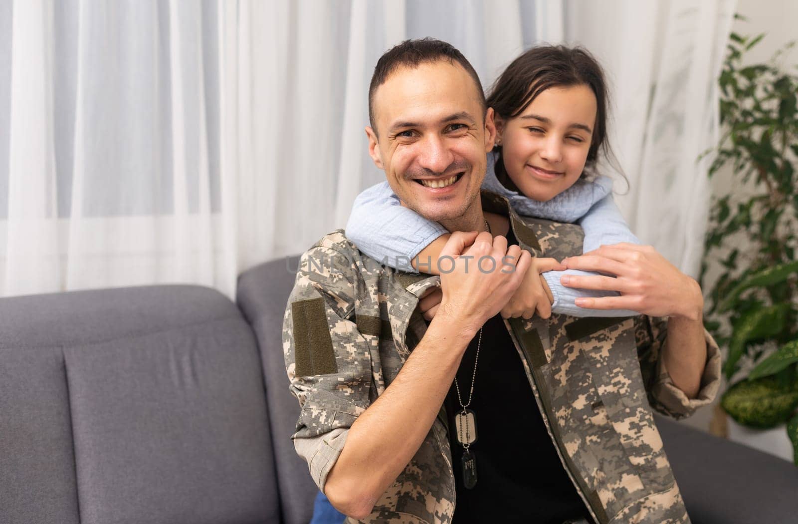 pretty little girl hugging her military father