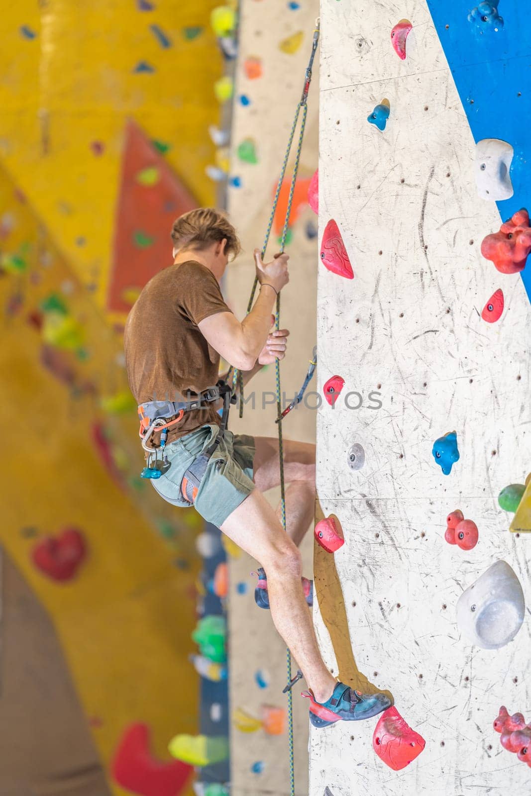 climber with safety rope on an artificial climbing wall. High quality photo
