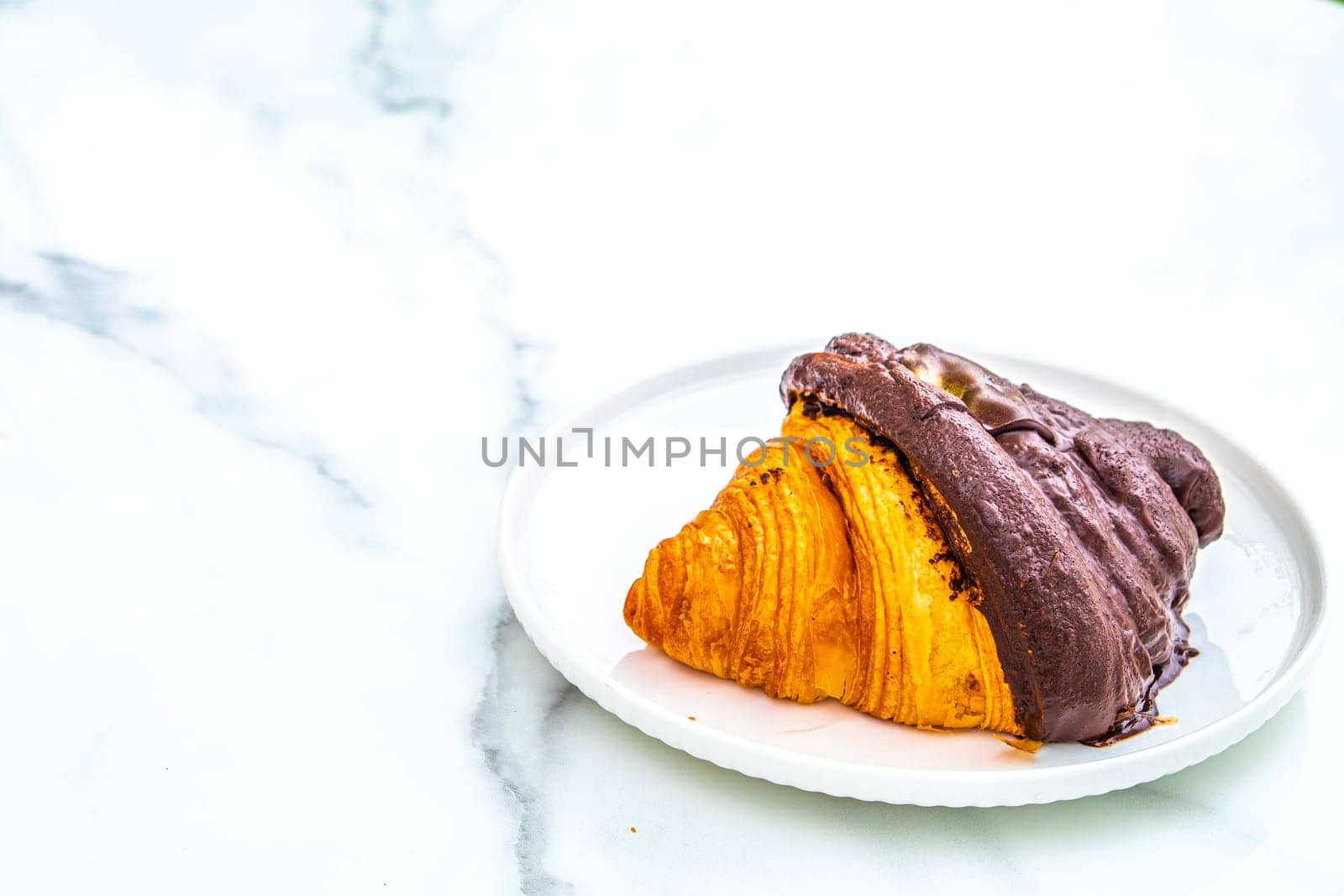 croissant with  chocolate on top.  breakfast background