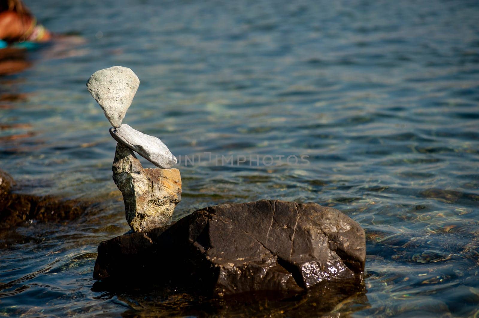 balanced stones on the rocks of the sea