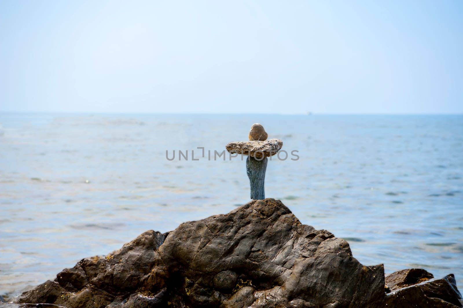 balanced stones on the rocks of the sea
