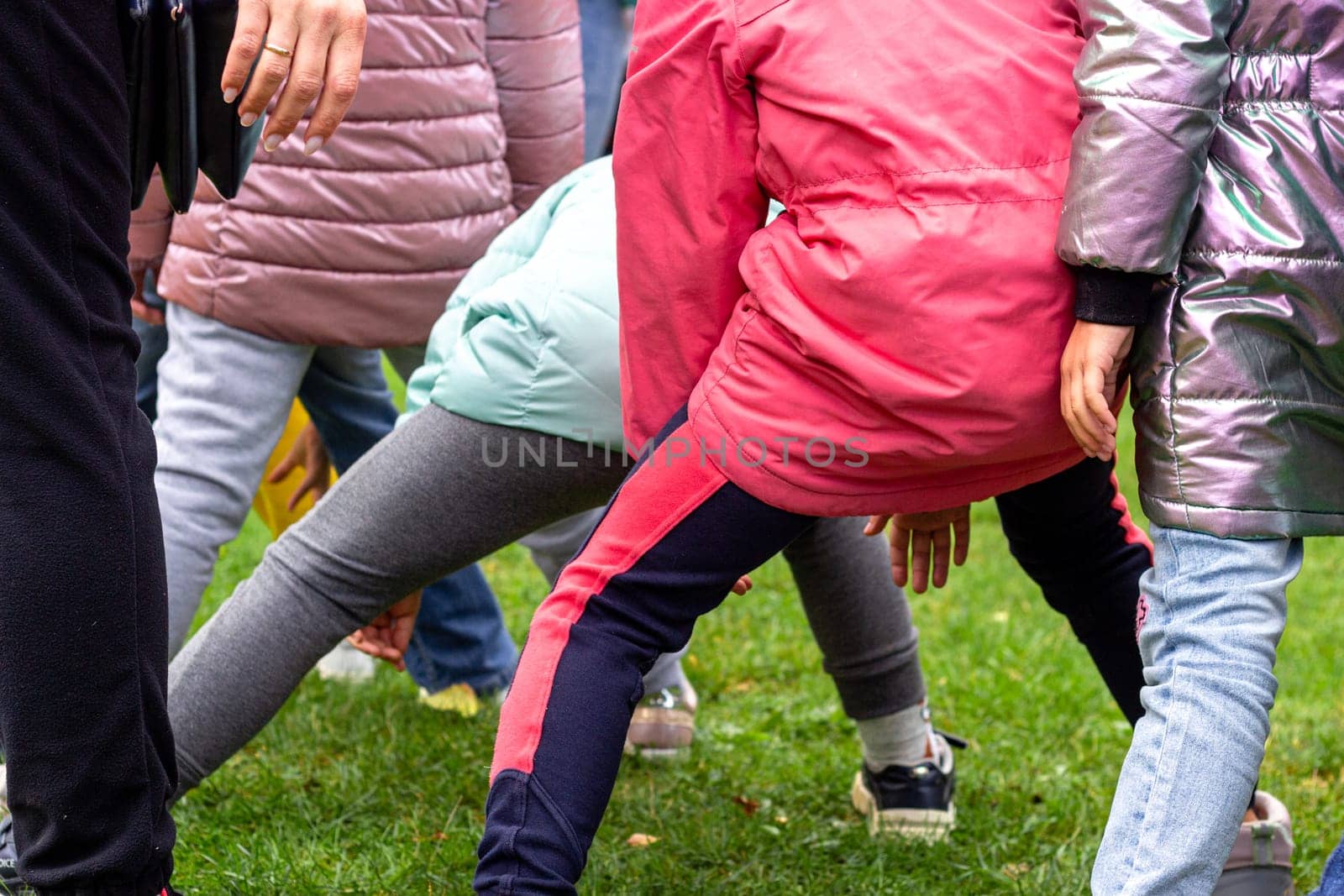 Photo children in jackets playing outdoor games by electrovenik
