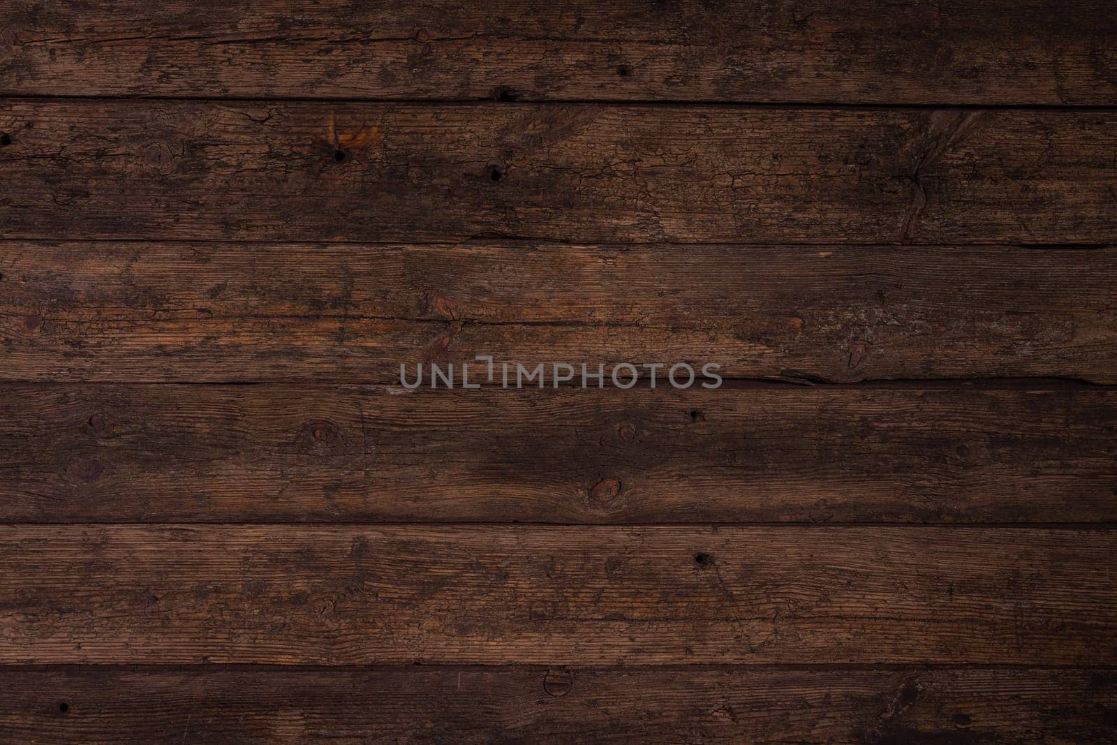 Several horizontally stacked old boards in clothes of brown color. Background of natural material slightly tattered.