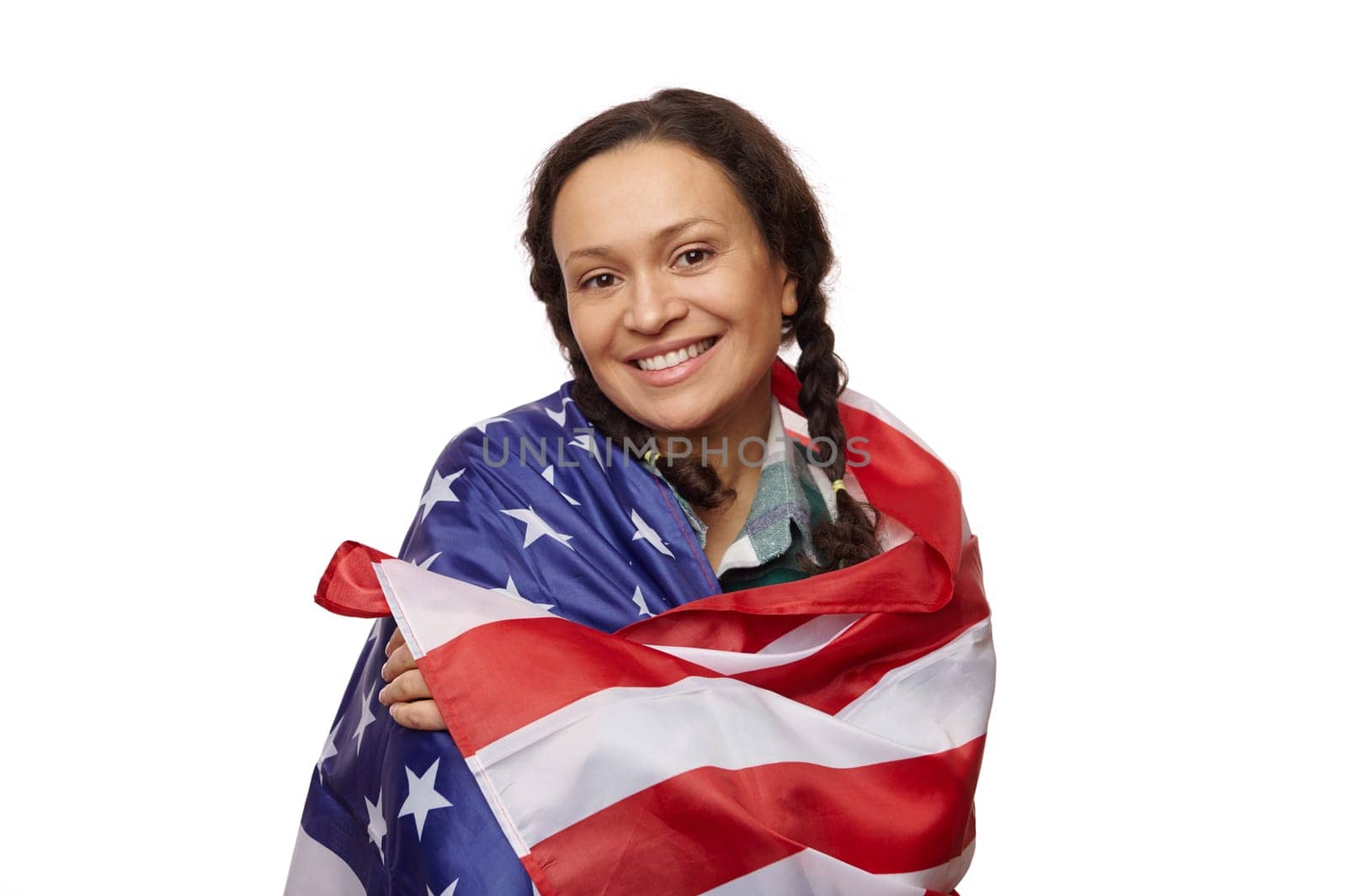 Isolated portrait on white background of charming ethnic middle-aged woman, smiling at camera, wrapped in USA flag by artgf
