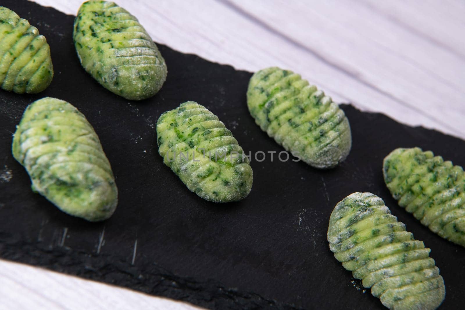 Pile of green spinach gnocchi, potato peru italian food, Homemade, High quality photo