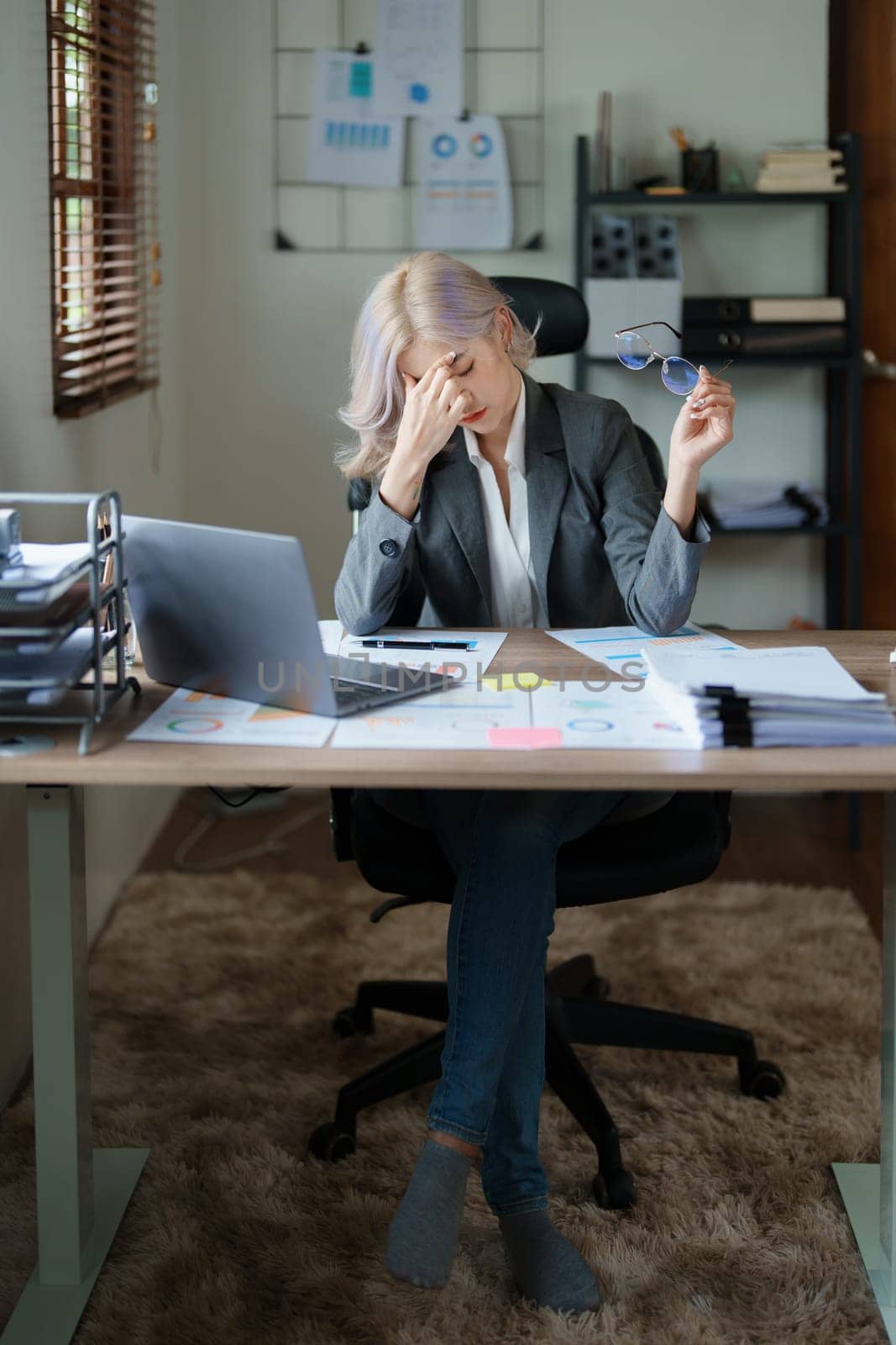 Portrait of sme business owner, woman using computer and financial statements Anxious expression on expanding the market to increase the ability to invest in business.