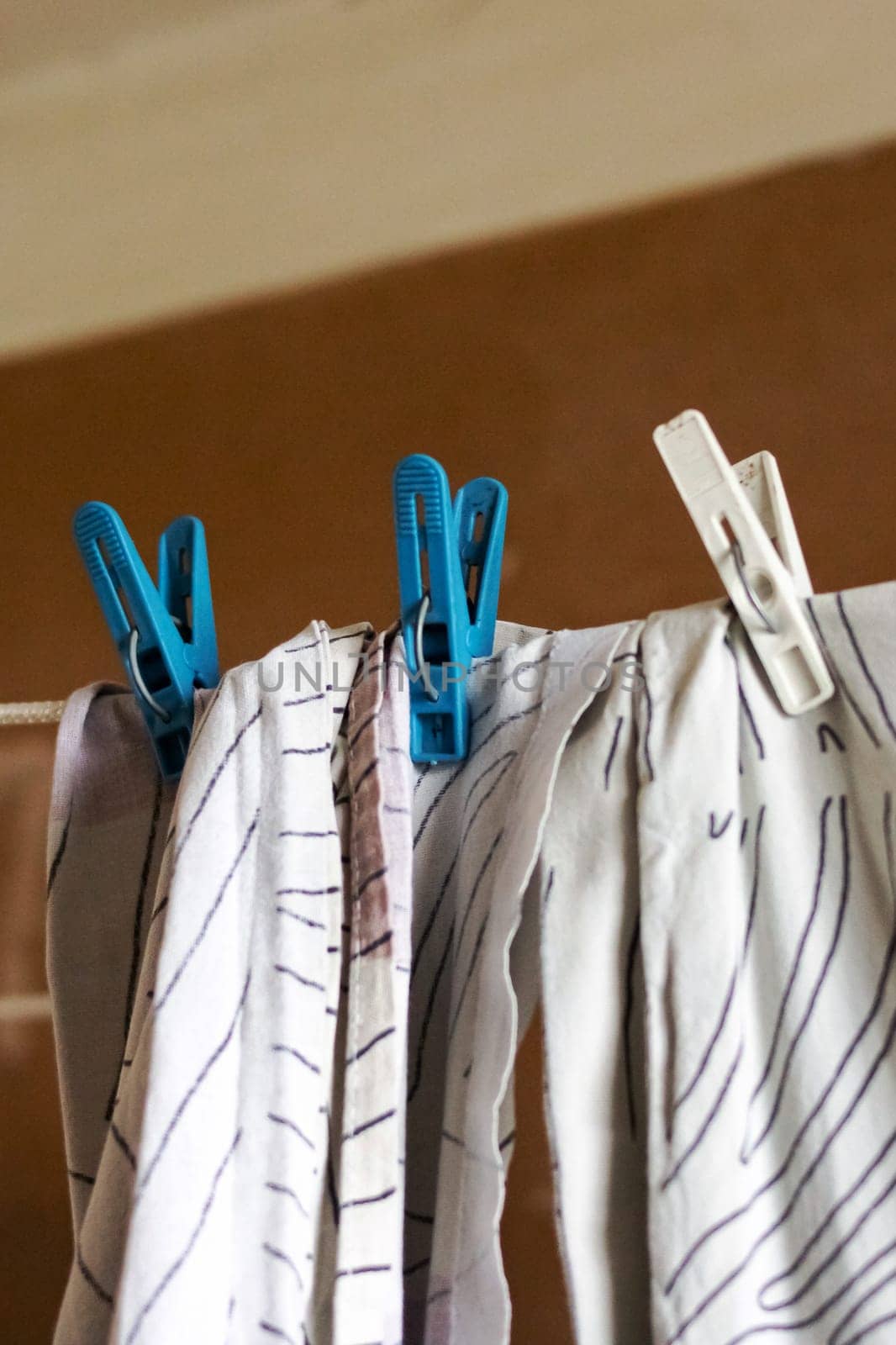 Laundry washed on a rope is dried close up