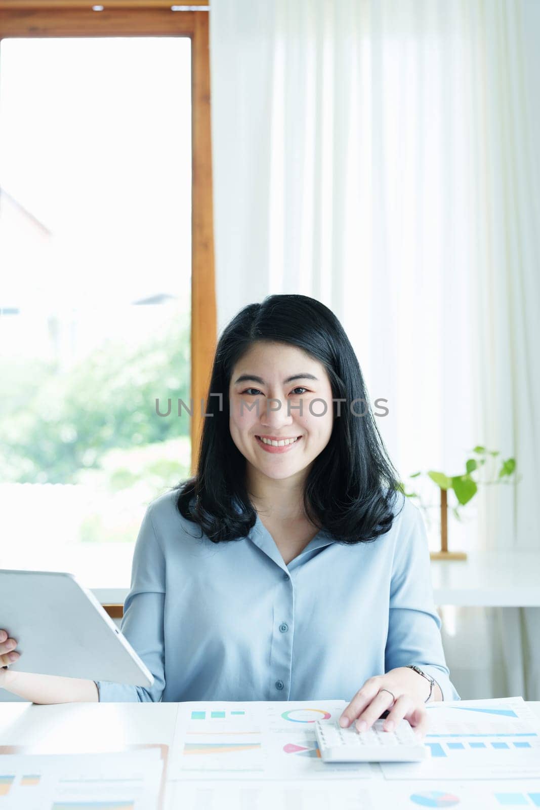 financial, Planning, Marketing and Accounting, portrait of Asian employee checking financial statements using documents and calculators at work..