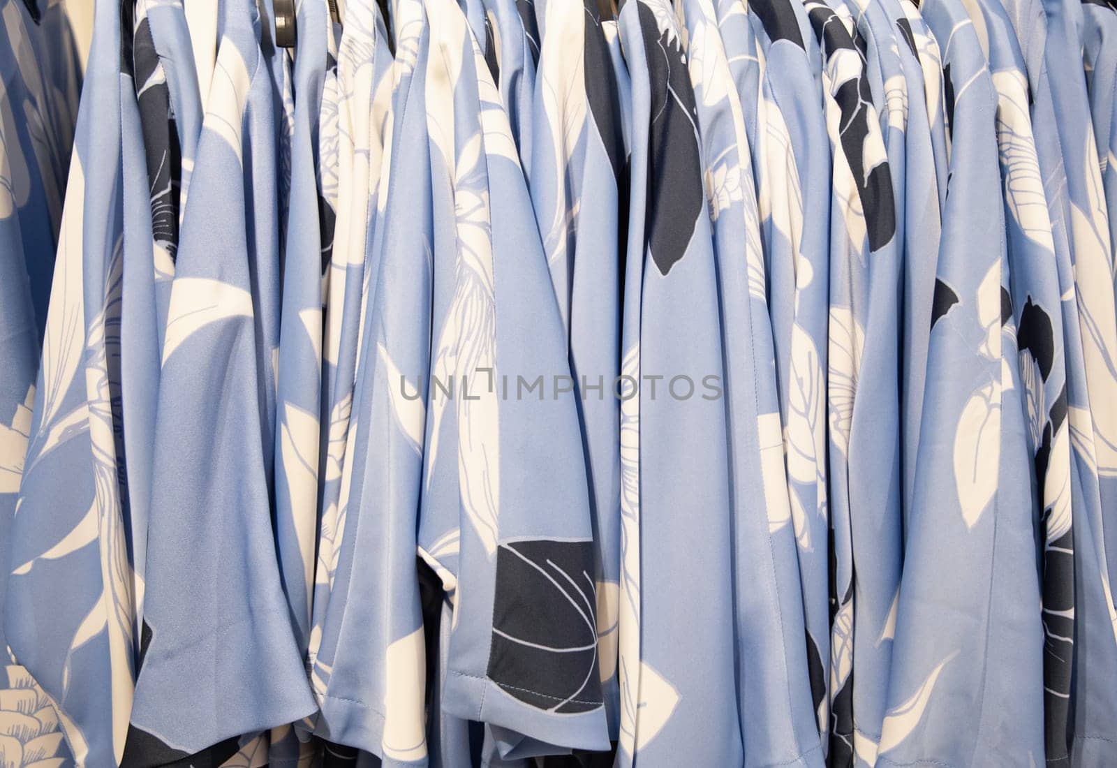 blue and white summer blouses on a hanger in the store, bright summer clothes, High quality photo
