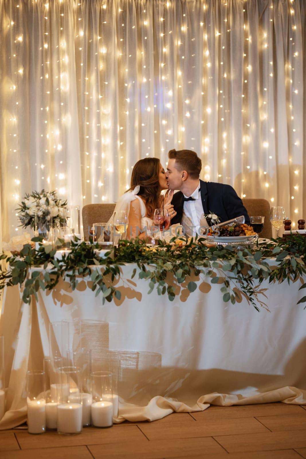 portrait of the newlyweds at the presidium at the wedding banquet