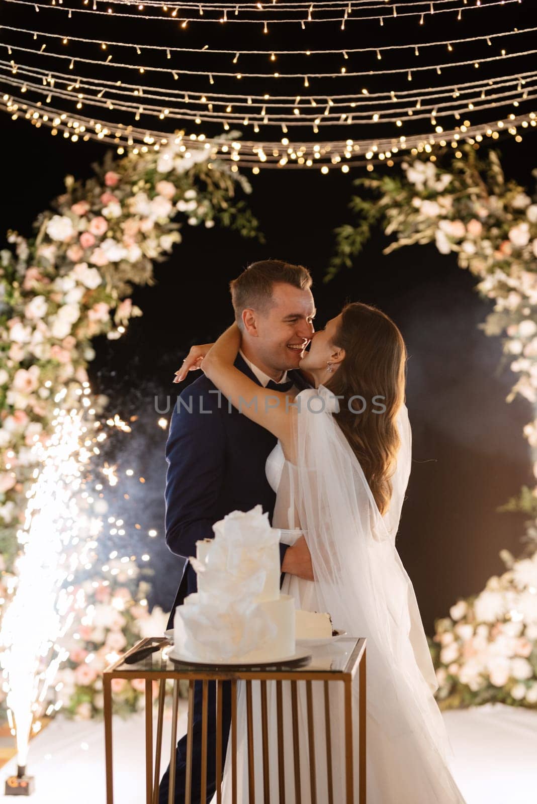 newlyweds happily cut, laugh and taste the wedding cake