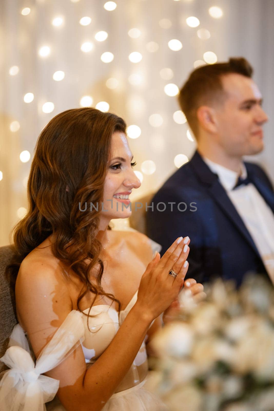 portrait of the newlyweds at the presidium at the wedding banquet