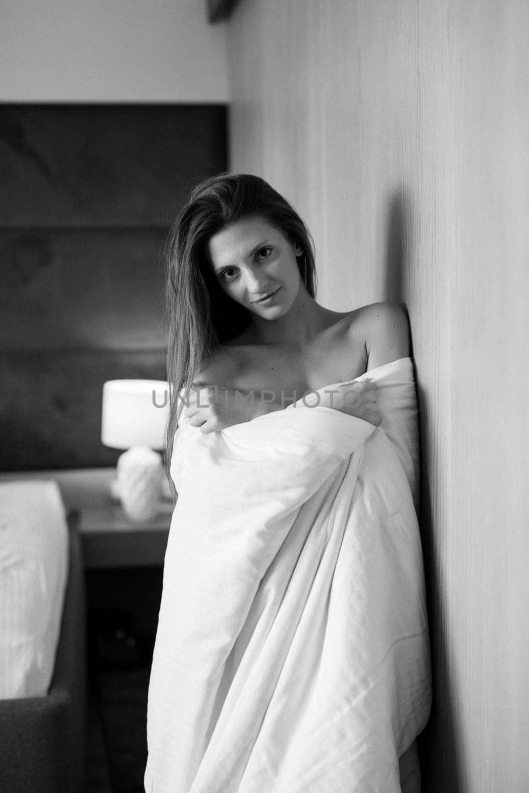 smiling girl bride woke up in the morning in a blanket
